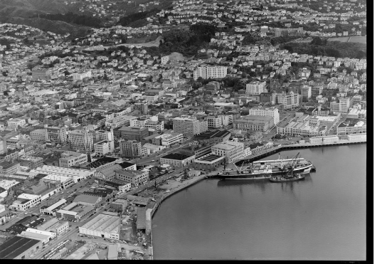 Wellington Harbour southern wharf area with Cable and Taranaki Streets and city, with Kelburn Park and Victoria University, Wellington City. Whites Aviation Ltd :Photographs. Ref: WA-40792-G. Alexander Turnbull Library, Wellington, New Zealand. http://natlib.govt.nz/records/30113905