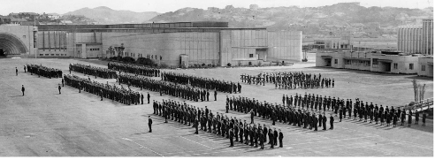1942 - The Centennial Exhibition buildings and fire station. National Library reference: Rows of Royal New Zealand Air Force members, Rongotai, Wellington. Evatt, G S: Photographs, chiefly regarding the Royal New Zealand Air Force during World War II. Ref: 1/2-106363-F. Alexander Turnbull Library, Wellington, New Zealand. http://natlib.govt.nz/records/22529245